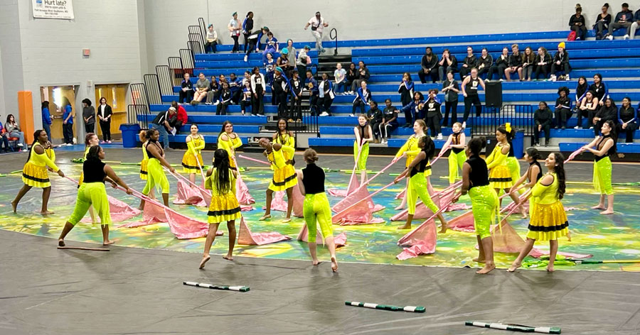 photo of color guard members performing in gym