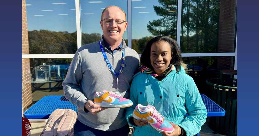 photo of superintendent with O I S student and her new shoes