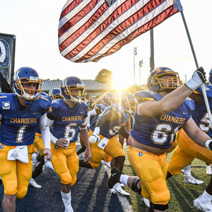photo of football players running onto field